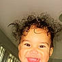 toddler, child, smiling, happy, curly_hair, face, indoors, window, blinds, ceiling_fan, cute, joyful, portrait, baby, expression, playful, person, head, bright, closeup