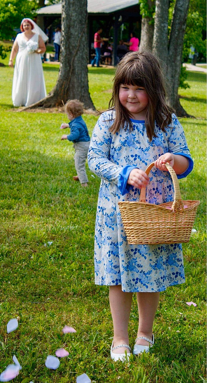 Kinsley is registered to the contest to win money with this photo: basket, blue, blurred, child, clothing, electric_blue, event, fun, grass, grass_family, green, happy, joy, lawn, leisure, pattern, people_in_nature, person, photograph, plant