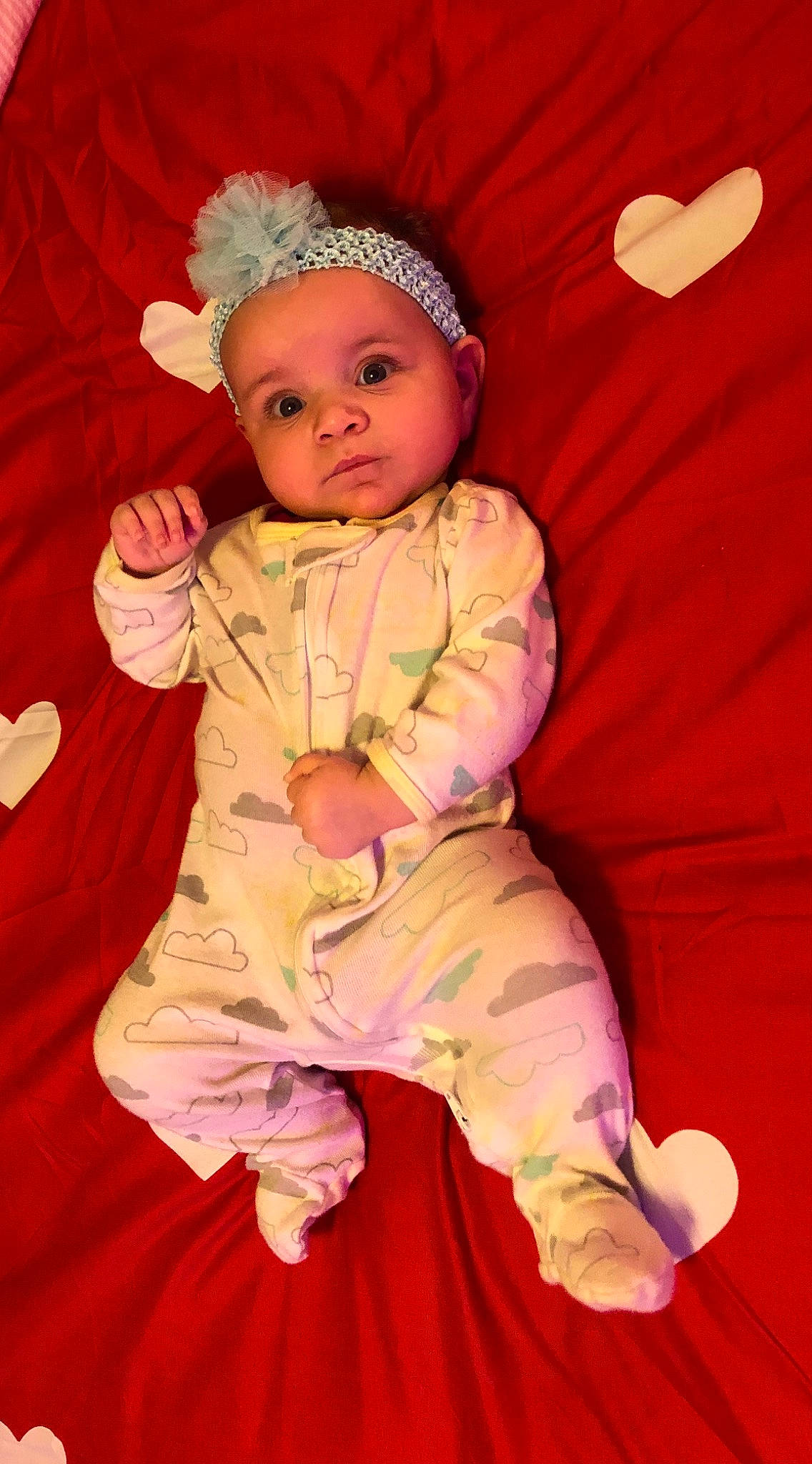 Italy is registered to the contest to win money with this photo: baby, baby_products, baby_toddler_clothing, cheek, child, comfort, costume_hat, eye, fun, fur, happy, headwear, linens, magenta, orange, pattern, peach, person, pink, sitting