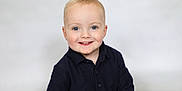 Frankie is registered to the contest to win money with this photo: baby, blond_hair, blue_eyes, casual_clothing, child, cute, face, friendly, happy, headshot, innocent, light_background, navy_clothing, person, portrait, smiling, studio_photo, sweater, toddler, young_child