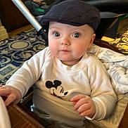 Frankie is registered to the contest to win money with this photo: adult, baby, baseballcap, bodypart, cap, clothing, face, finger, footwear, furniture, hand, hat, head, male, man, person, photography, portrait, shoe, wood