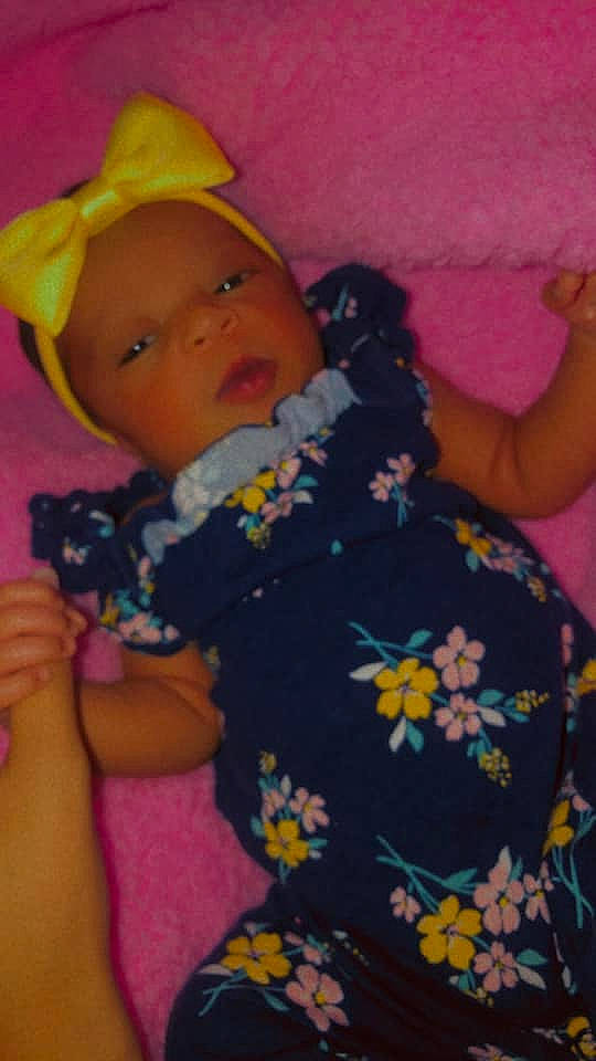 Danielle is registered to the contest to win money with this photo: arm, baby, baby_toddler_clothing, cap, cheek, child, comfort, facial_expression, finger, fun, hairstyle, happy, headwear, human_body, mouth, nose, person, pink, purple, skin