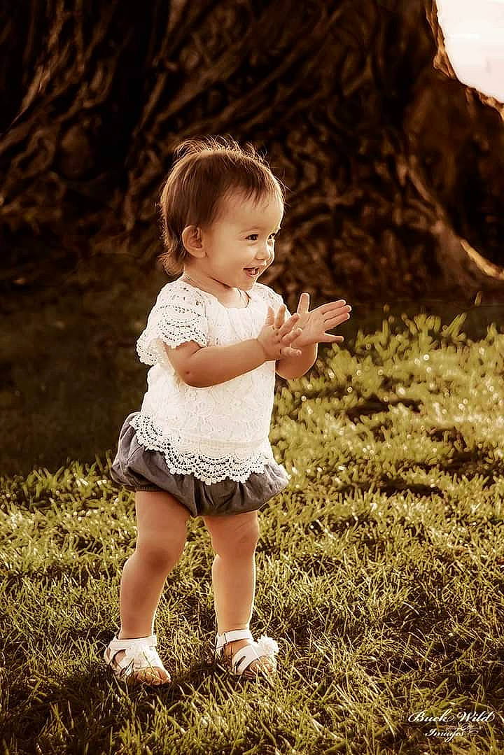 Lyriq is registered to the contest to win money with this photo: baby, baby_toddler_clothing, brown_hair, flash_photography, fun, grass, grass_family, grassland, hair, happy, human_leg, people_in_nature, person, plant, portrait_photography, sitting, skin, smile, standing, toddler