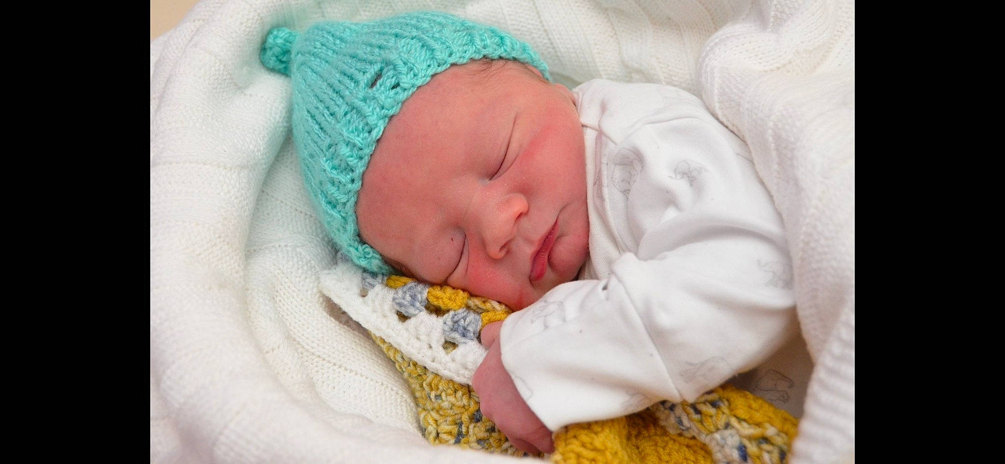 Freddie is registered to the contest to win money with this photo: baby, baby_products, baby_sleeping, baby_toddler_clothing, bedtime, cap, comfort, event, hand, hat, headgear, headwear, knit_cap, linens, nap, person, room, skin, sleep, textile