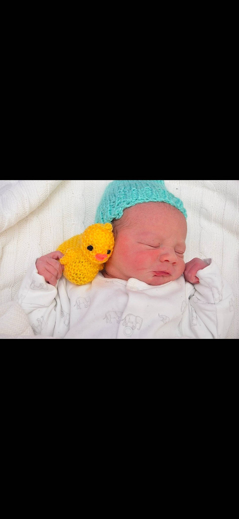 Freddie is registered to the contest to win money with this photo: baby, baby_products, baby_sleeping, baby_toddler_clothing, baby_toys, beanie, bedtime, cap, child, comfort, fictional_character, knit_cap, linens, person, room, sitting, stuffed_toy, t_shirt, toddler, toy