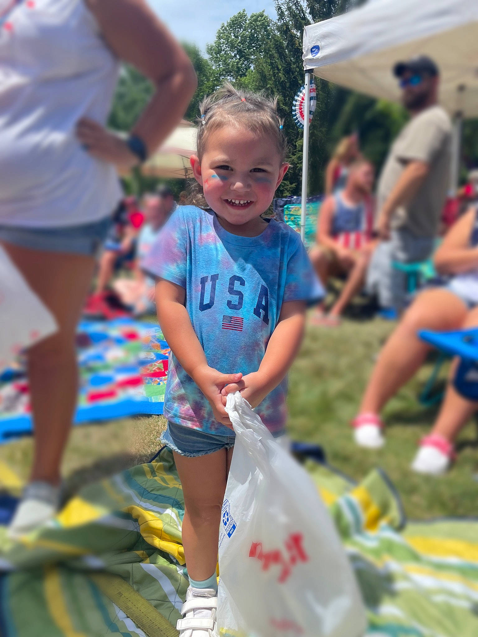 Kehlanii is registered to the contest to win money with this photo: child, crowd, event, fun, grass, happy, hat, joy, leisure, person, play, public_event, recreation, shoe, shorts, smile, sneakers, style, t_shirt, toddler