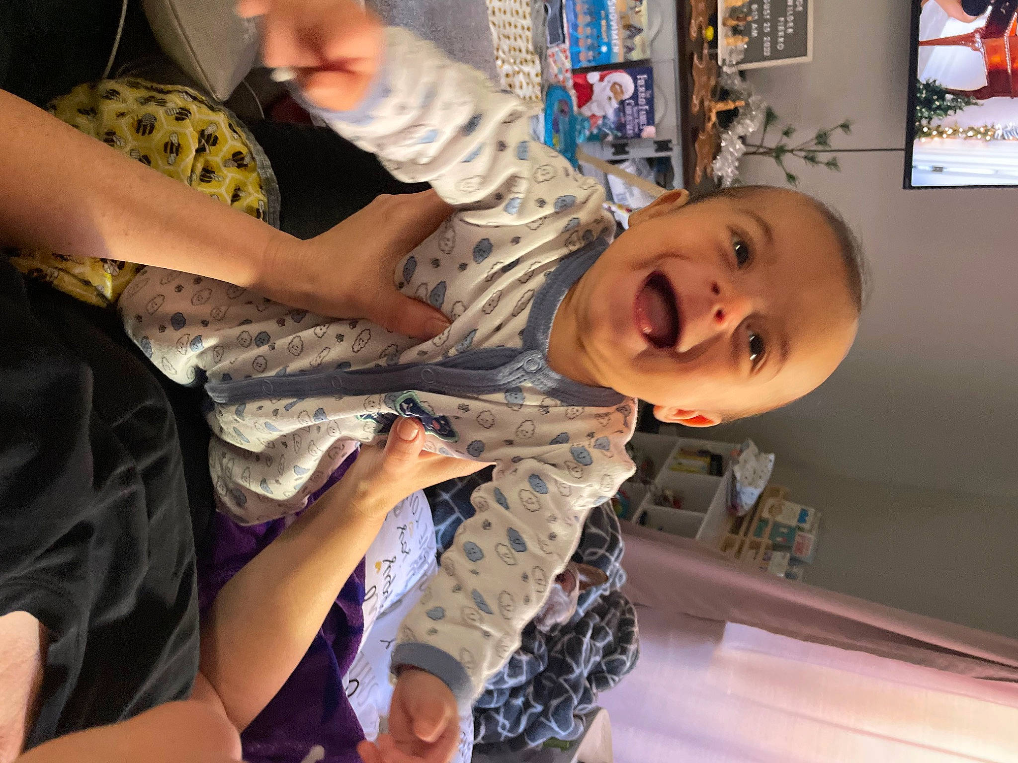 Gaige is registered to the contest to win money with this photo: arm, art, baby, baby_laughing, child, elbow, finger, fun, gesture, hand, happy, military_camouflage, pattern, person, picture_frame, play, room, smile, thumb, toddler