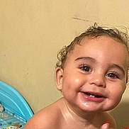 Elijah is registered to the contest to win money with this photo: toddler, child, smiling, indoor, bed, bedframe, curly_hair, happy, face, portrait, young_child, skin, eyes, teeth, bedroom, pillow, blanket, person, baby, closeup