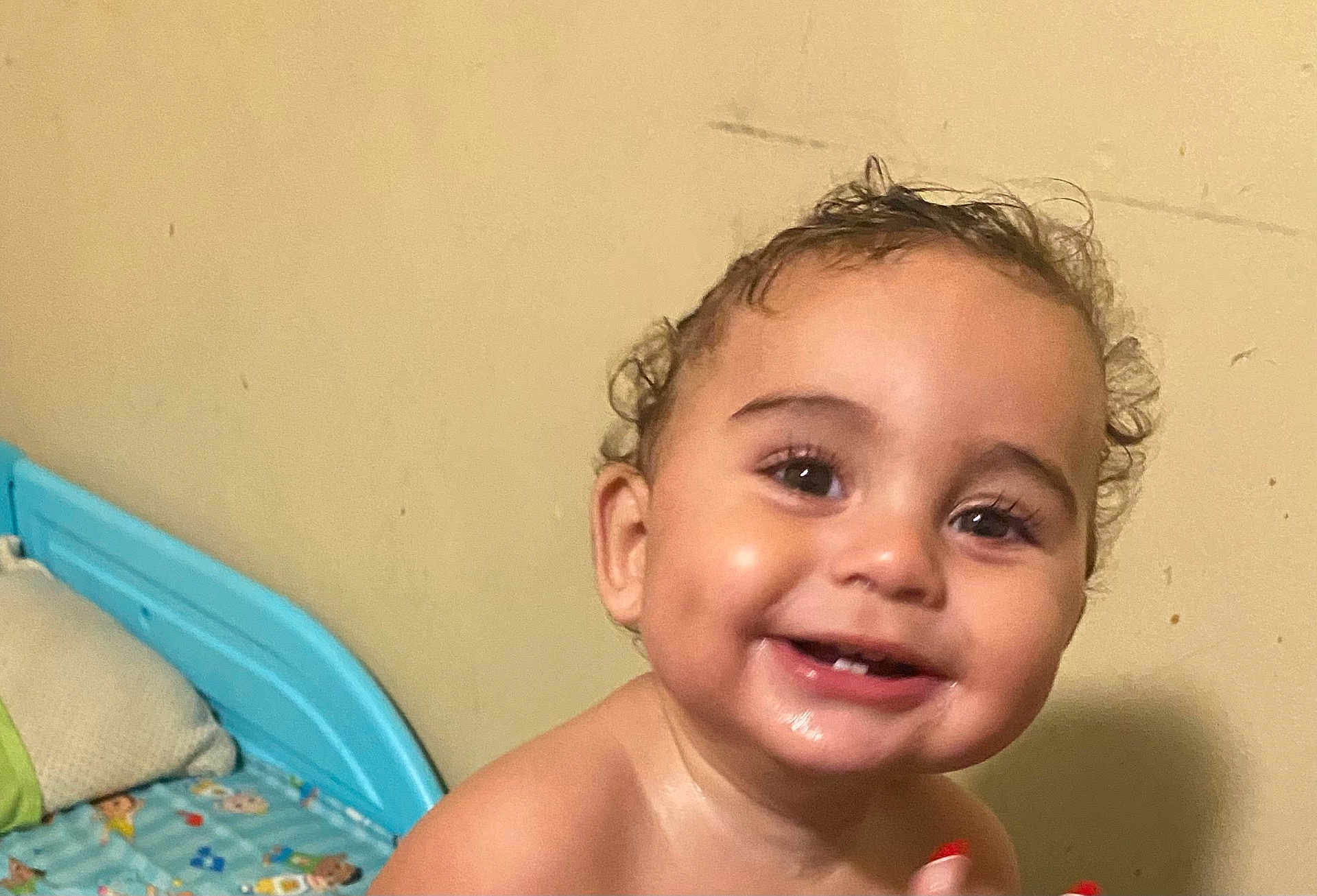 Elijah is registered to the contest to win money with this photo: toddler, child, smiling, indoor, bed, bedframe, curly_hair, happy, face, portrait, young_child, skin, eyes, teeth, bedroom, pillow, blanket, person, baby, closeup