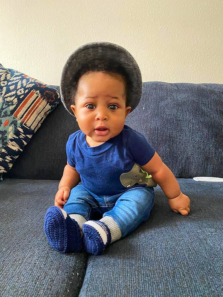 Declan joined the competition — help win amazing prizes! baby, baby_toddler_clothing, black_hair, cheek, child, comfort, couch, electric_blue, eye, face, flash_photography, flooring, hair, happy, head, person, skin, sleeve, t_shirt, tints_and_shades