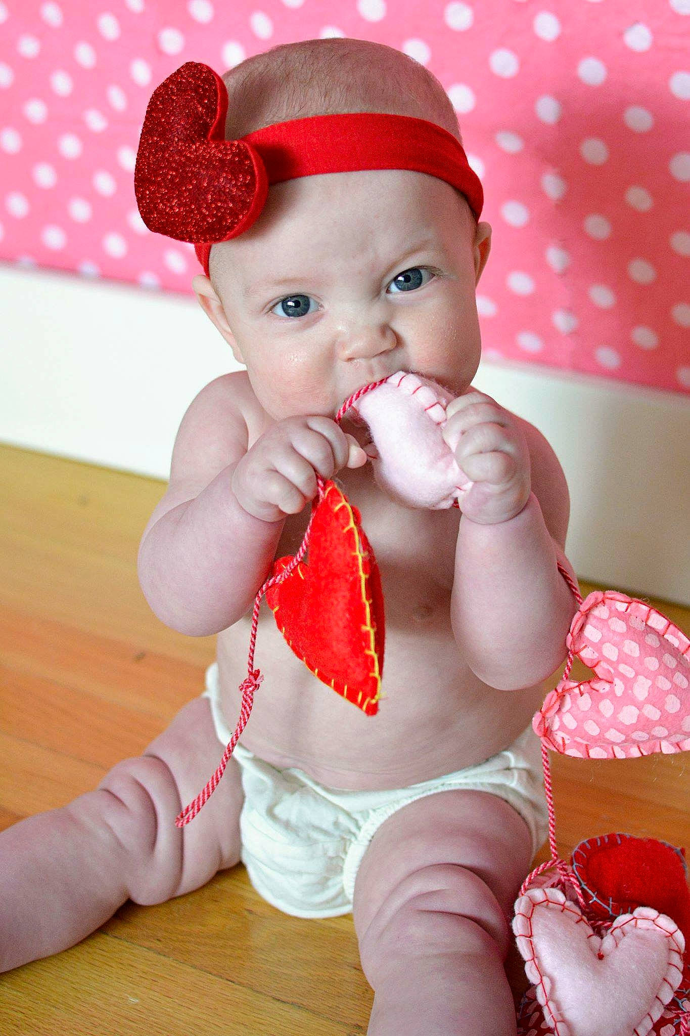 Whitley is registered to the contest to win money with this photo: baby, baby_toddler_clothing, cap, cheek, child, finger, happy, hat, headwear, human_leg, leg, lip, nail, pattern, person, pink, skin, sleeve, thigh, thumb