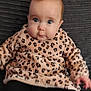 baby, black_leggings, cheeks, child, clothing, couch, curious, cute, eyes, face, indoors, infant, leopard_print, person, portrait, pout, sitting, sweater, texture, young_child