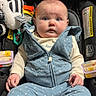 baby, child, infant, car_seat, zebra_toy, plush_toy, portrait, sitting, indoors, vehicle, blue_clothing, polka_dots, wide_eyed, looking_at_camera, face, hands, socks, harness, stroller, cute
