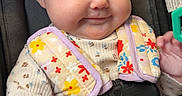 Berkley joined the competition — help win amazing prizes! baby, infant, child, smiling, portrait, car_seat, safety_harness, buckle, floral_clothing, bib, outdoor, vehicle, seated, face, blue_eyes, fair_skin, hand, reaching, close_up, happy