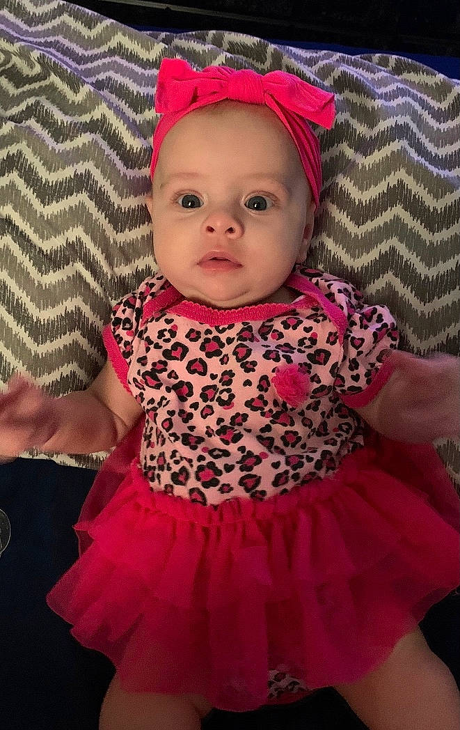 Clementine is registered to the contest to win money with this photo: baby, baby_toddler_clothing, cap, cheek, child, day_dress, dress, eye, iris, lip, magenta, organ, person, pink, product, purple, skin, sleeve, textile, toddler