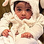 Isabel joined the competition — help win amazing prizes! baby, child, hoodie, bunny_ears, white_clothing, fluffy, cute, portrait, face, hands, infant, looking_at_camera, indoor, soft_texture, warm_lighting, expression, wrapped, sitting, young_child, adorable