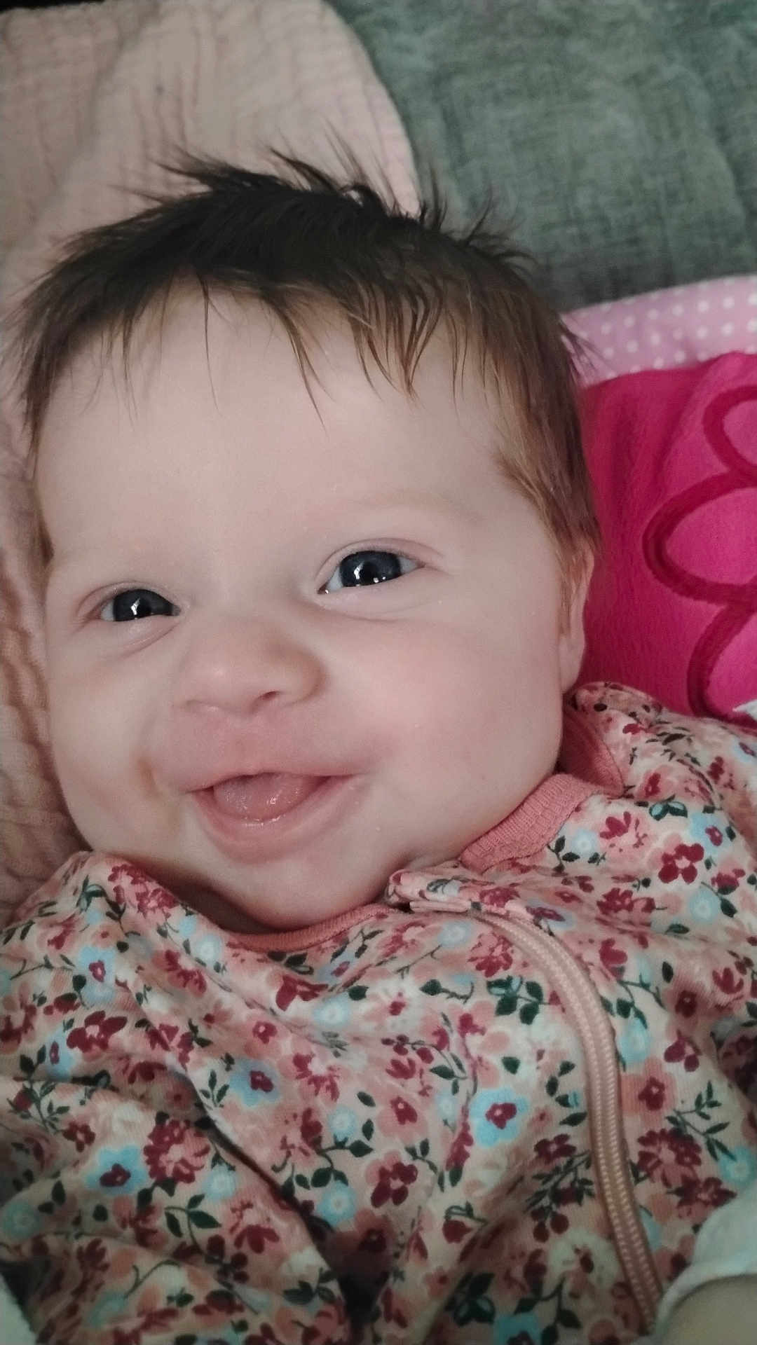 Alazea is registered to the contest to win money with this photo: baby, smiling, face, portrait, child, infant, happy, clothing, floral_pattern, cute, close_up, pink, blue, soft_texture, expression, young_child, skin, head, eyes, indoors