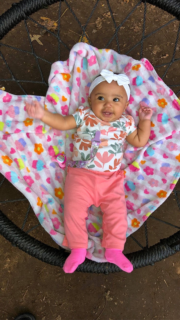 Makinsley joined the competition — help win amazing prizes! baby, baby_products, baby_toddler_clothing, child, clothing, comfort, fashion_accessory, grass, happy, headwear, linens, magenta, outerwear, pattern, person, pink, play, sitting, sleeve, smile