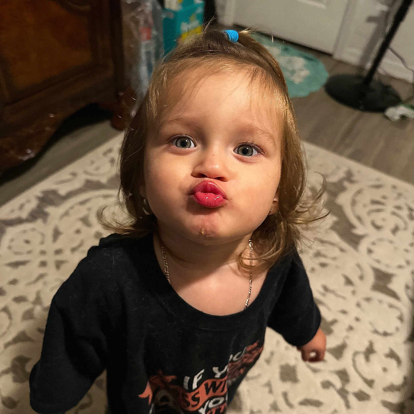 Paris is registered to the contest to win money with this photo: accessories, baby, blonde, bodypart, clothing, face, finger, hand, hardwood, head, jewelry, longsleeve, mouth, necklace, person, photography, portrait, sleeve, t_shirt, wood