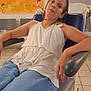 Maëwen a rejoint le concours — aidez-le/la à gagner de superbes lots ! arm, armrest, blue_jeans, casual_clothing, child, face, head, hospital, indoor, medical_chair, person, poster, relaxed, seated, tile_floor, waiting_room, wall_art, wheelchair, white_top, young_person