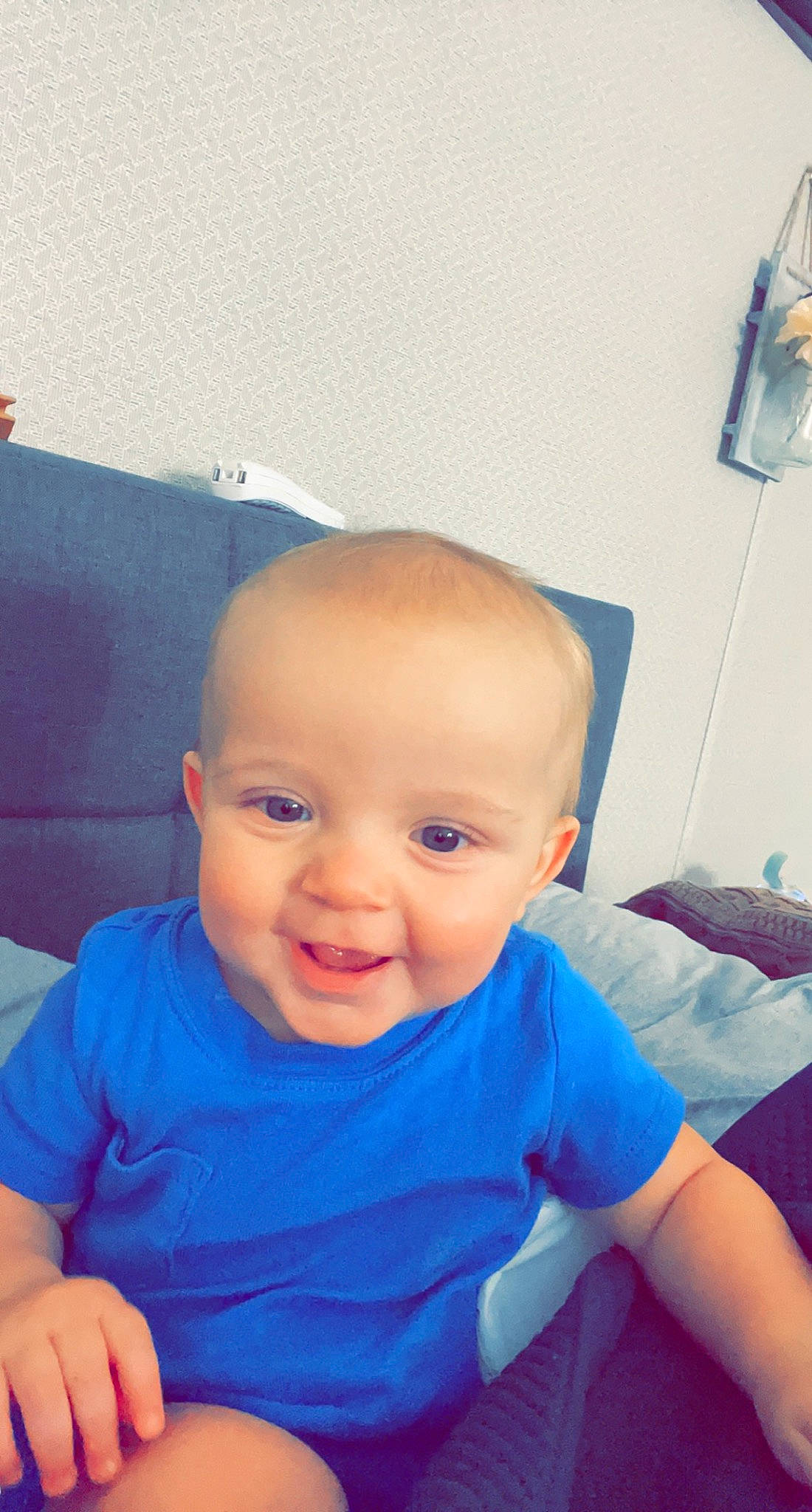 Michael is registered to the contest to win money with this photo: baby, baby_toddler_clothing, blue, cheek, child, electric_blue, eye, fun, happy, head, iris, mouth, nose, person, sitting, skin, sleeve, smile, standing, t_shirt