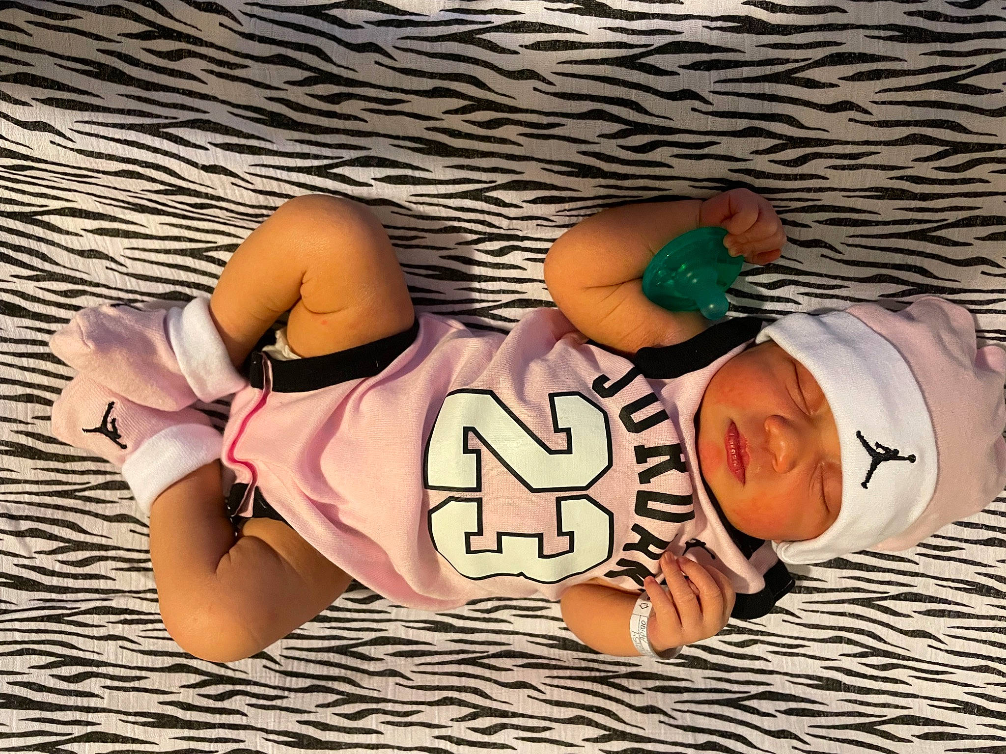 Zaliyah is registered to the contest to win money with this photo: abdomen, baseball_cap, cap, chest, elbow, finger, font, fun, happy, headwear, human_body, knee, leisure, person, sitting, sleeve, sportswear, t_shirt, thigh, trunk