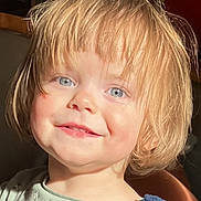 Cylia participe au concours pour gagner de l'argent avec cette photo : child, toddler, smile, blond_hair, blue_eyes, face, portrait, sunlight, rosy_cheeks, clothing, sweater, dress, indoors, cute, happy, young_child, person, headshot, expression, natural_light