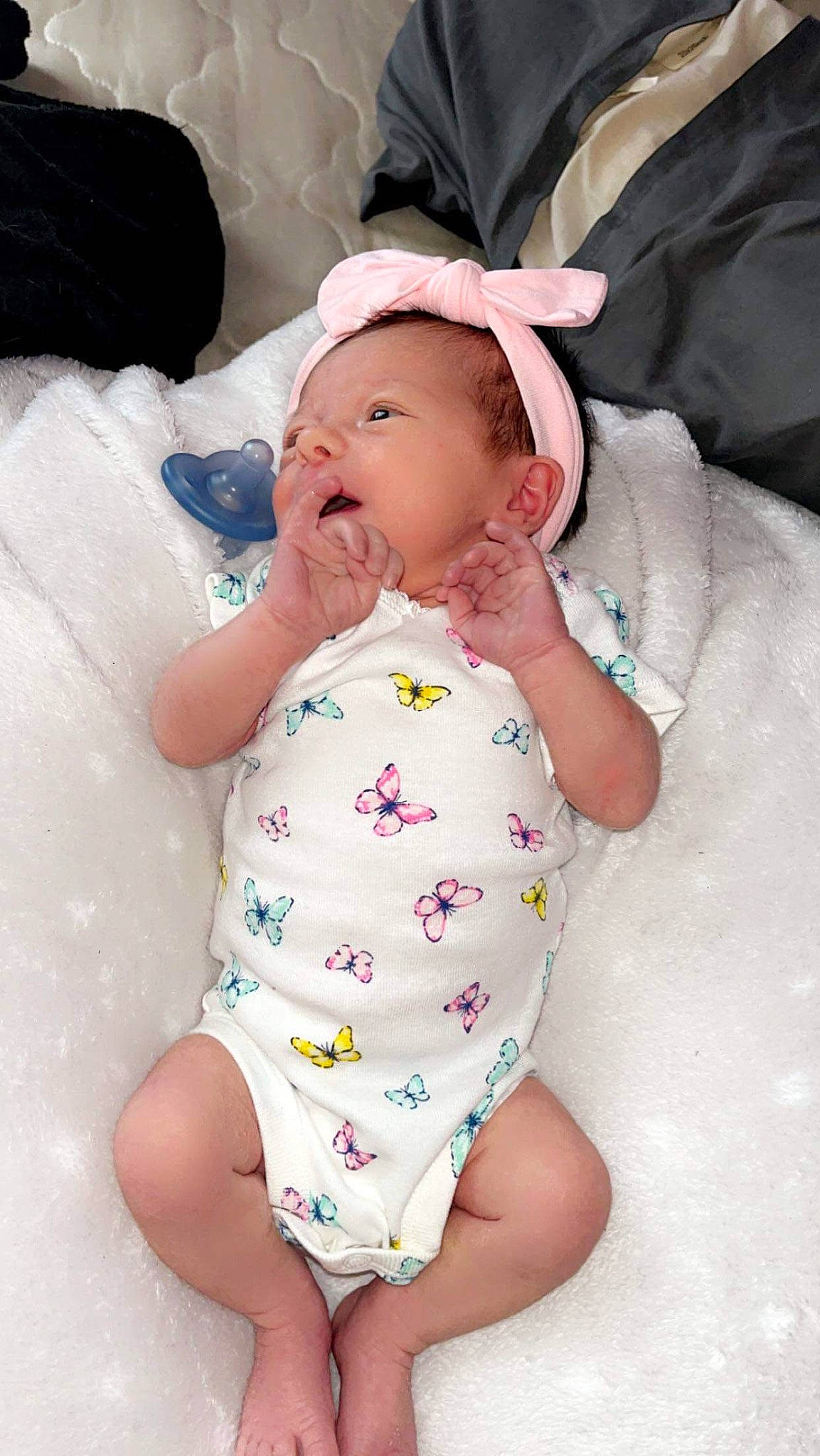 Arizona is registered to the contest to win money with this photo: abdomen, baby, baby_products, baby_sleeping, baby_toddler_clothing, cheek, child, comfort, head, linens, lip, pattern, person, pink, sitting, skin, sleeve, stomach, textile, thigh