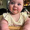 Collins is registered to the contest to win money with this photo: baby, child, blue_eyes, chubby_cheeks, high_chair, wooden, curious, food_smudge, indoor, portrait, cute, infant, yellow_clothing, striped, ruffles, soft_lighting, person, closeup, happy, smile