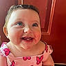 Collins is registered to the contest to win money with this photo: baby, child, smiling, blue_eyes, dress, pink, butterflies, closeup, portrait, happy, cute, indoor, skin, face, infant, person, young_child, expression, looking_up, cheerful