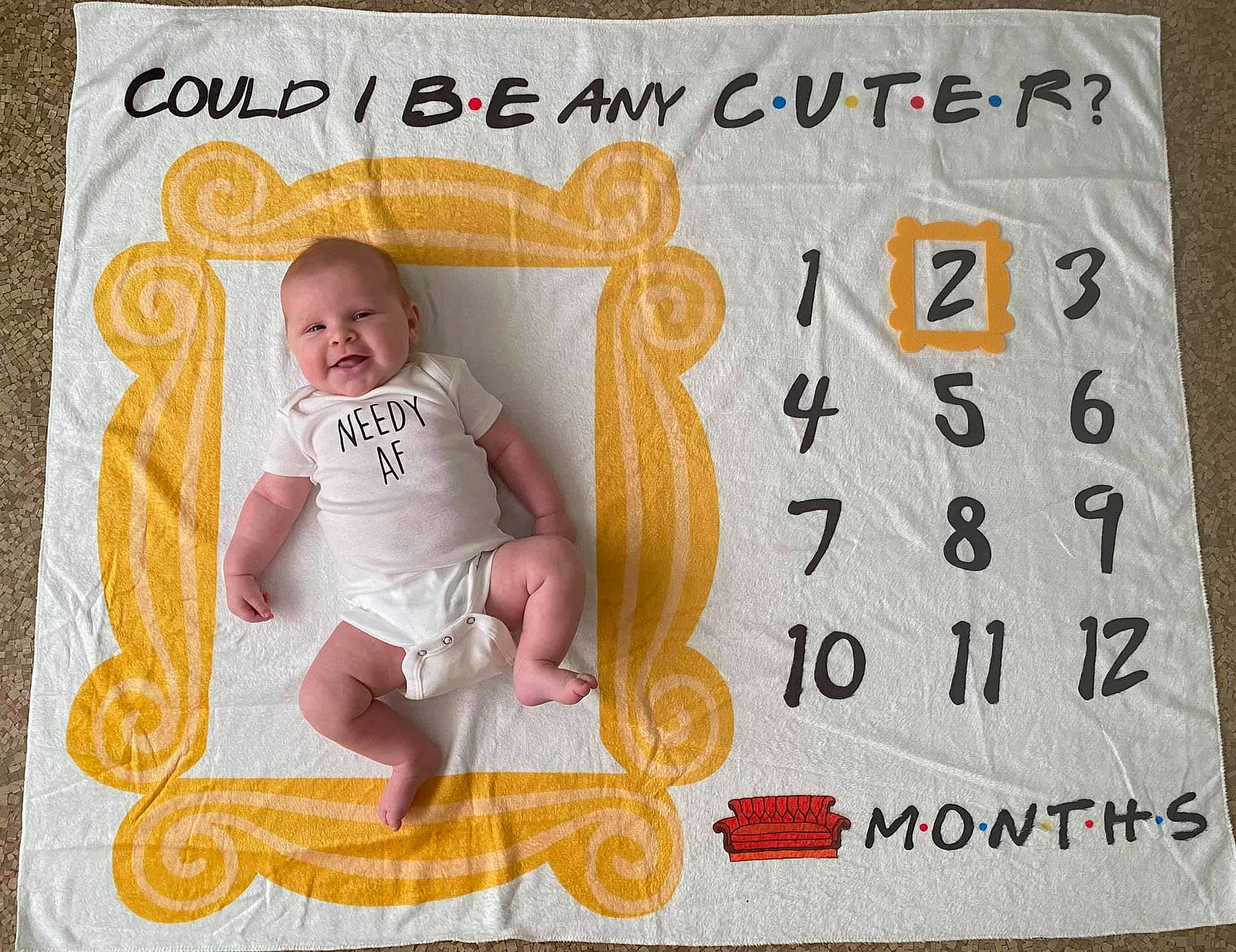 Noah is registered to the contest to win money with this photo: art, baby, baby_toddler_clothing, book, comfort, craft, creative_arts, design, facial_expression, font, happy, joy, linens, orange, paper, paper_product, pattern, person, product, publication
