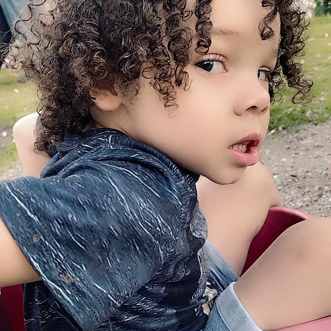 Karsen joined the competition — help win amazing prizes! boy, casual_clothing, child, curly_hair, daytime, expression, face, grass, hand, nature, outdoor, person, play, portrait, radio_flyer, shorts, side_view, summer, tshirt, wagon