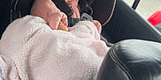 Naomi is registered to the contest to win money with this photo: baby, blanket, car, car_interior, car_seat, child, child_safety, cute, face, hoodie, pink, plush, portrait, seatbelt, smile, travel, warm, window, winter_clothing, young_child