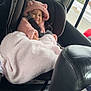 baby, child, car_seat, pink, blanket, hoodie, smile, face, window, car_interior, seatbelt, child_safety, cute, winter_clothing, plush, young_child, car, travel, portrait, warm