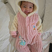 Aysha joined the competition — help win amazing prizes! animal_patch, baby, bed, bunny_ears, child, cozy, cream, cute, face, hood, infant, lying_down, onesie, pillow, pink, plush, portrait, sleepwear, smile, soft