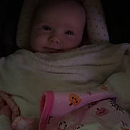 Salem is registered to the contest to win money with this photo: baby, blanket, child, clothing, comfort, cozy, cute, face, head, indoors, infant, pattern, person, pink, portrait, sleeping_bag, smile, soft, warm, wrapped