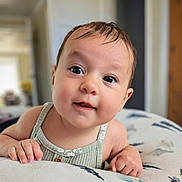 Lilah is registered to the contest to win money with this photo: baby, child, infant, face, eyes, hand, skin, clothing, cushion, indoor, portrait, curious, expression, person, young, cute, home, soft, focus, closeup