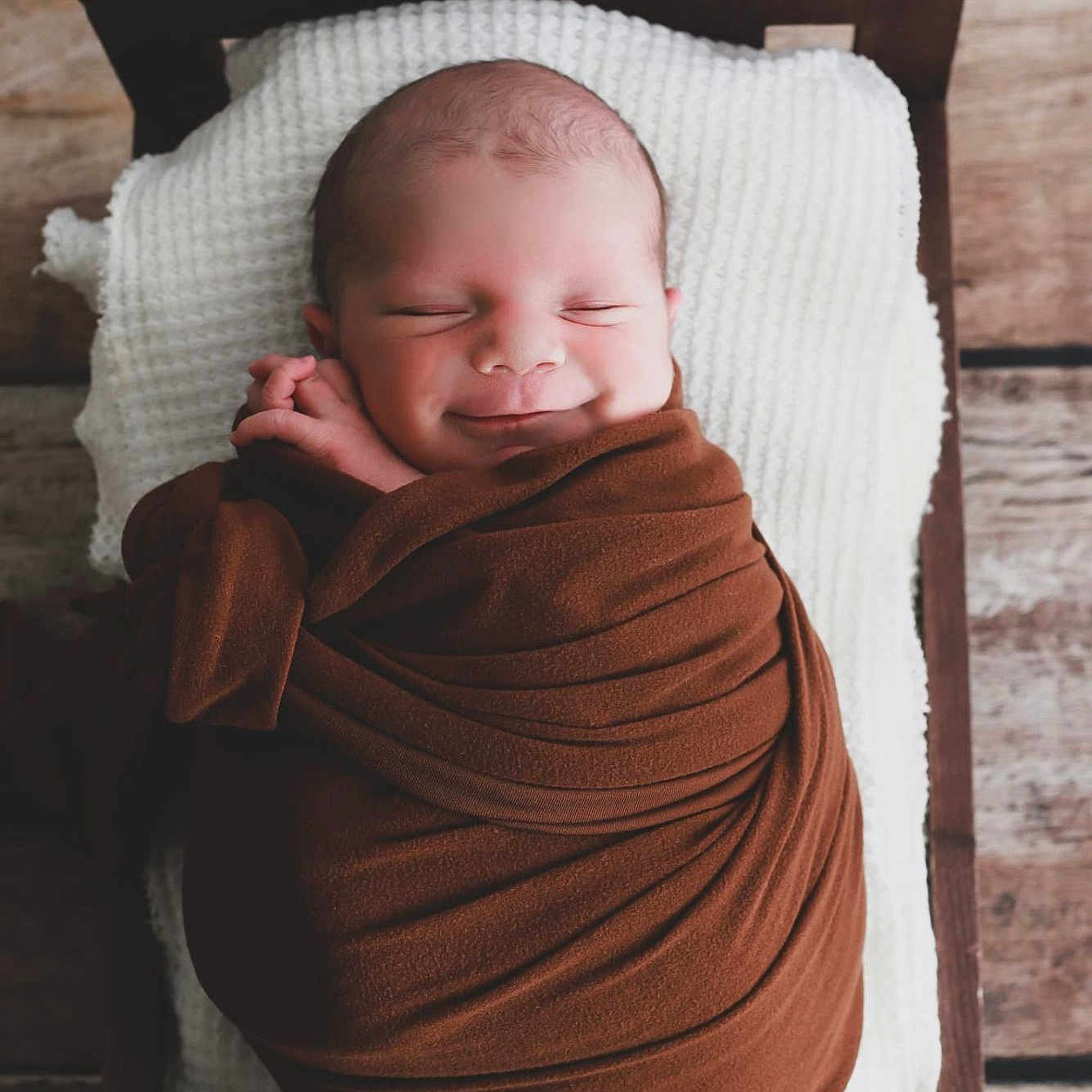 Aaron participe au concours pour gagner de l'argent avec cette photo : baby, blanket, child, cozy, cute, face, indoors, infant, newborn, peaceful, pillow, portrait, resting, sleeping, smiling, soft_texture, swaddled, wood_floor, wooden_bed, wrapped