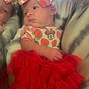 Serenity is registered to the contest to win money with this photo: baby, infant, newborn, girl, bow_headband, minnie_mouse, strawberry_print, red_tutu, dress, mirror_reflection, hand, arm, portrait, indoor, curtain, blanket, clothing, head, cheeks, cute