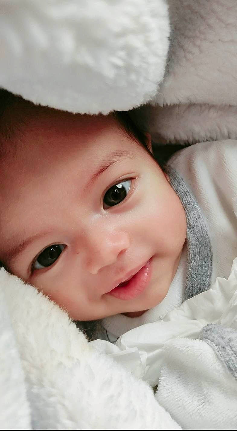 Tariq participe au concours pour gagner de l'argent avec cette photo : baby, baby_toddler_clothing, cap, cheek, eye, eyebrow, eyelash, face, flash_photography, happy, headwear, iris, lip, nose, person, photograph, pink, skin, sleeve, smile