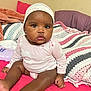 Naleighna joined the competition — help win amazing prizes! baby, infant, child, pink_bedspread, crocheted_blanket, head_wrap, long_sleeve_onesie, indoors, bed, curious_expression, soft_lighting, cute, sitting, person, skin, face, hand, foot, room, cozy