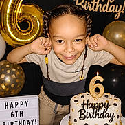 Jayden joined the competition — help win amazing prizes! child, birthday, six_years_old, smiling, portrait, cake, birthday_cake, number_six, candles, balloons, gold_decorations, black_decorations, braids, celebration, party, indoors, happy, flexing, confetti, birthday_sign