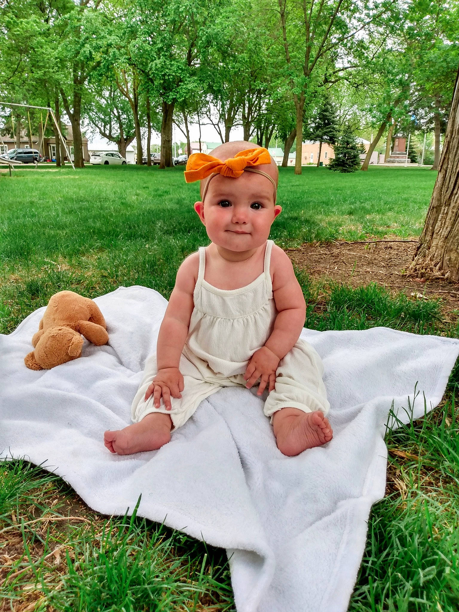 Murphy joined the competition — help win amazing prizes! baby, child, costume, dress, fawn, grass, hair_accessory, headgear, headwear, joy, person, plant, sitting, smile, summer, toddler, tree
