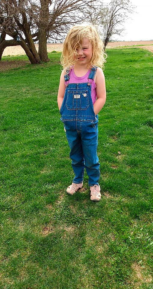 Brynlee is registered to the contest to win money with this photo: child, clothing, denim, fun, grass, jeans, joy, lawn, overall, person, plant, summer, textile, toddler, trousers