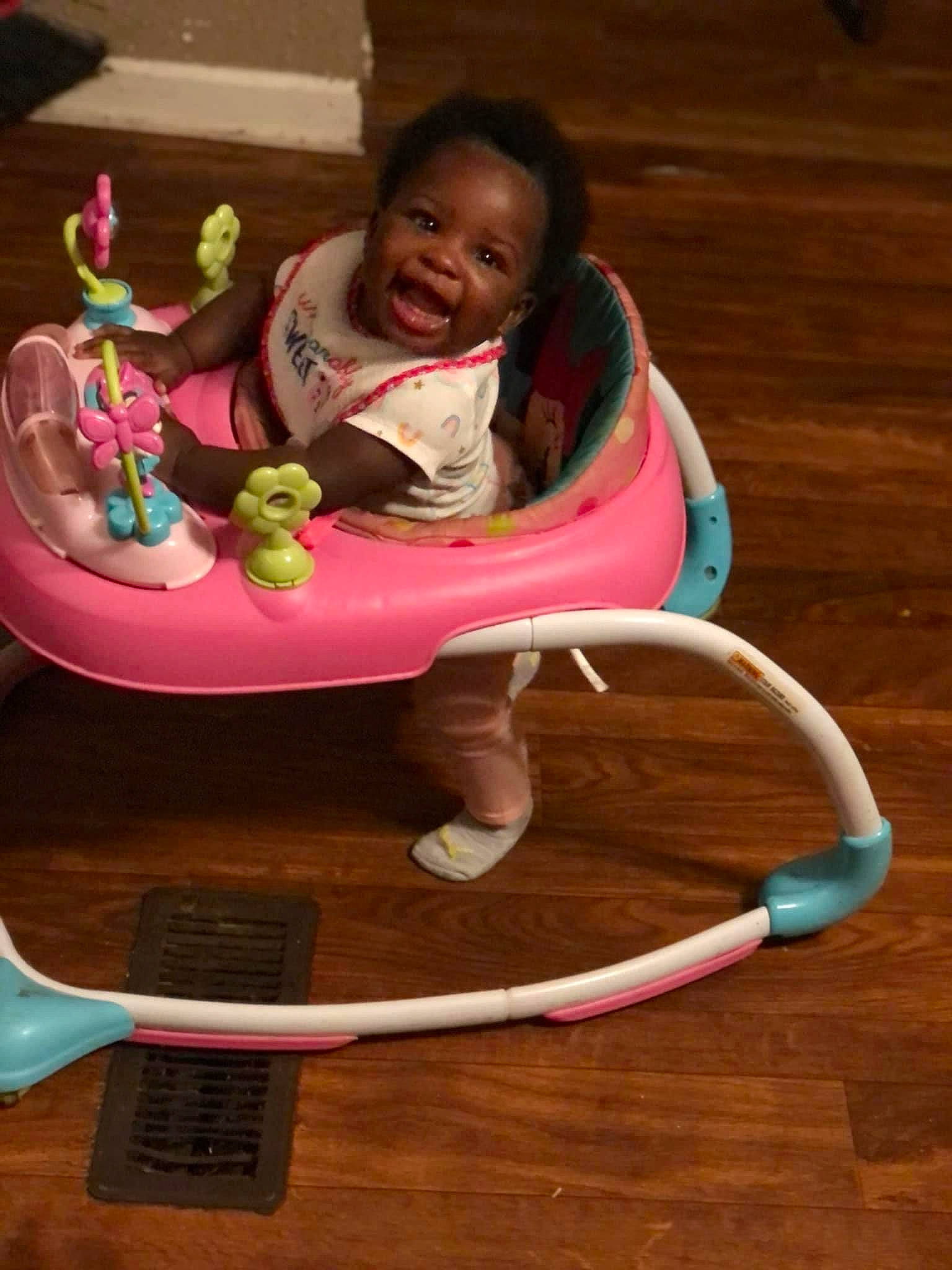 Majesty is registered to the contest to win money with this photo: baby, baby_products, baby_toddler_clothing, baby_toys, chair, child, comfort, flooring, happy, hardwood, leisure, magenta, person, pink, sharing, sitting, smile, table, toddler, toy