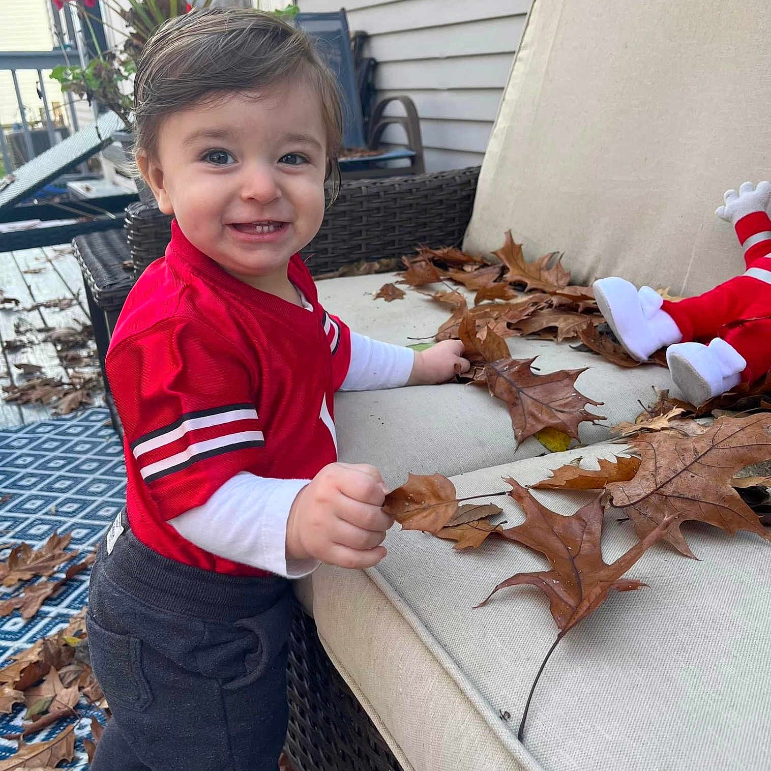 Grayson is registered to the contest to win money with this photo: boy, child, clothing, coat, face, footwear, furniture, head, jacket, jeans, leaf, male, pants, person, photography, plant, portrait, pottedplant, shoe, tree