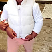 Wakoli Ursule a rejoint le concours — aidez-le/la à gagner de superbes lots ! toddler, child, indoor, flooring, white_vest, pink_leggings, socks, hair_beads, hand, person, curious, standing, young_child, cute, clothing, floor, wooden_floor, support, beads, portrait