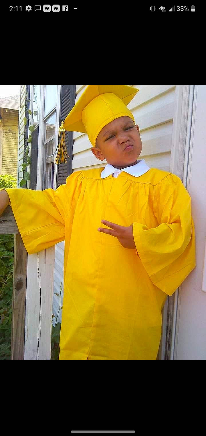 Jay is registered to the contest to win money with this photo: anger, cap, child, costume, costume_hat, fun, gesture, happy, headgear, headwear, magenta, orange, person, personal_protective_equipment, plant, room, shorts, sleeve, street_fashion, t_shirt