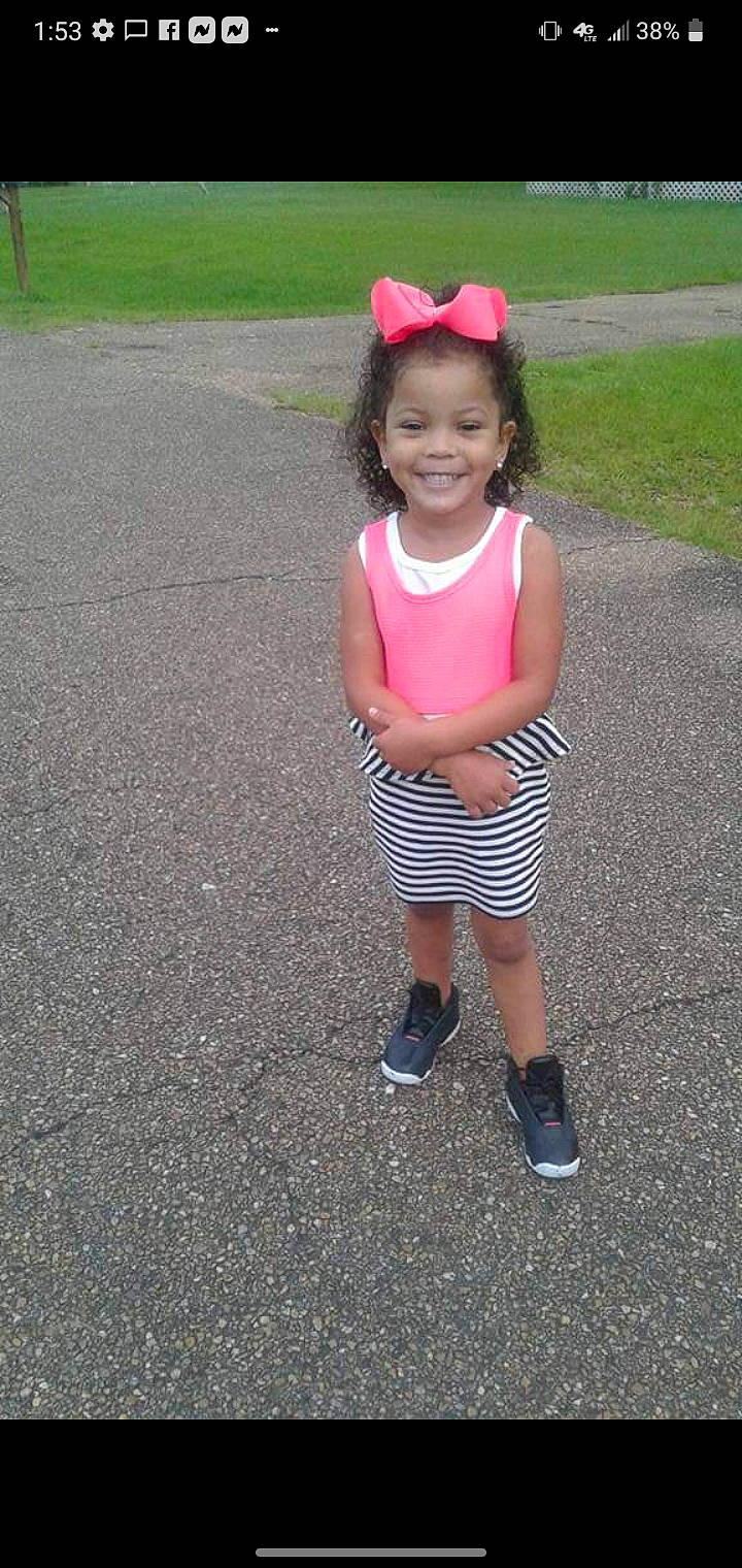 Harmony is registered to the contest to win money with this photo: asphalt, baby_toddler_clothing, child, face, facial_expression, fun, grass, hairstyle, happy, head, joy, magenta, pattern, person, pink, recreation, road_surface, shorts, sleeve, smile