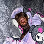 dog, sleeping, blanket, cozy, snuggled, soft, purple, pink, cartoon_pattern, cute, pet, napping, fur, nose, closeup, indoor, comfort, rest, relaxed, animal